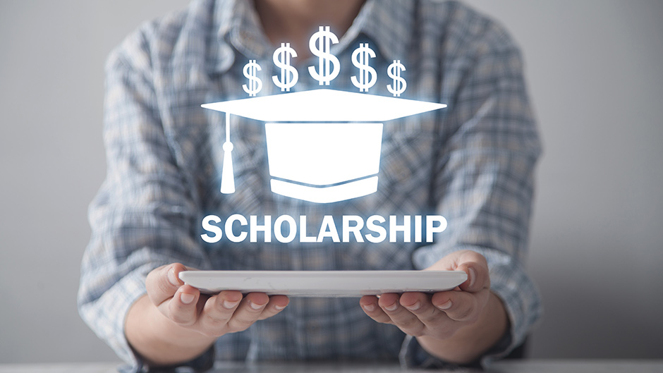 Scholarship text floating above a laptop