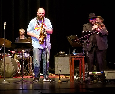 three performers on stage