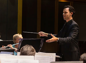 Maxwell conducting the orchestra