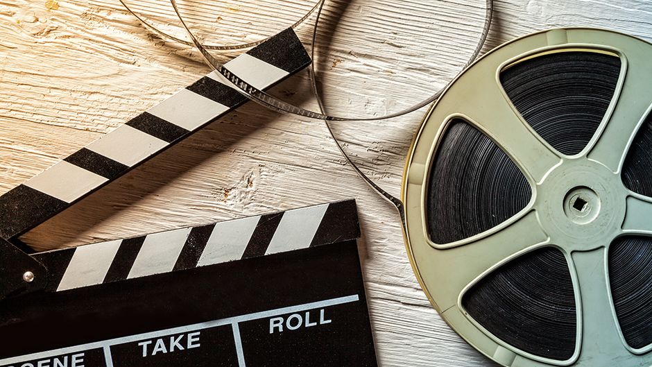 A film clapboard and reel of film