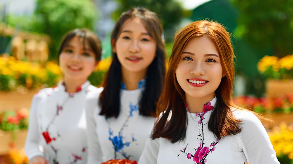 Three women wearing traditional Vietnamese clothing