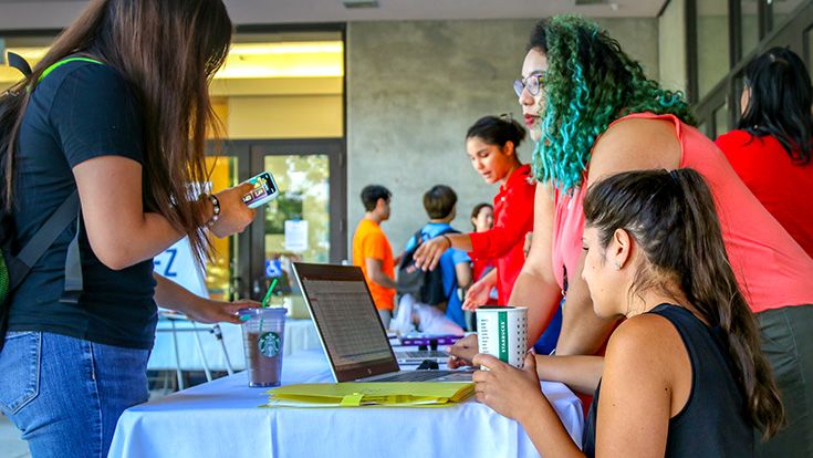 CRC Outreach staff talking to future students at an event