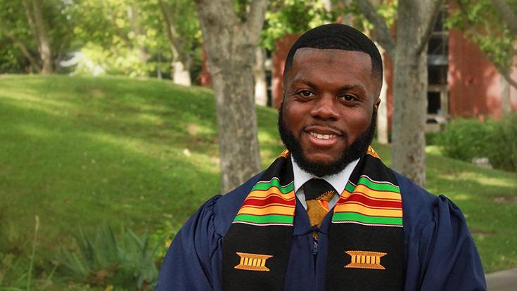 A student dressed in graduation attire