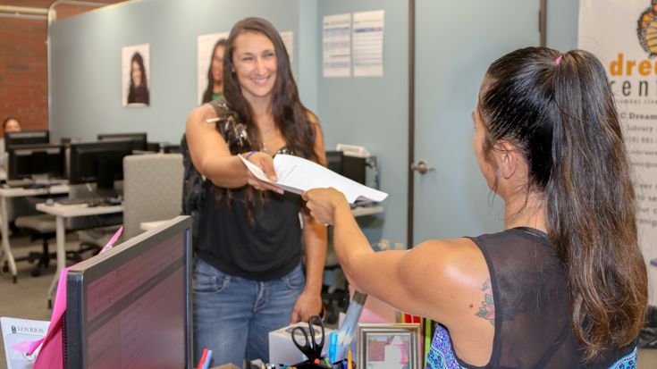 Student receiving paperwork help at CRC's Student Access Center.
