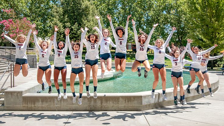 CRC Women's Volleyball team jumping into the air together