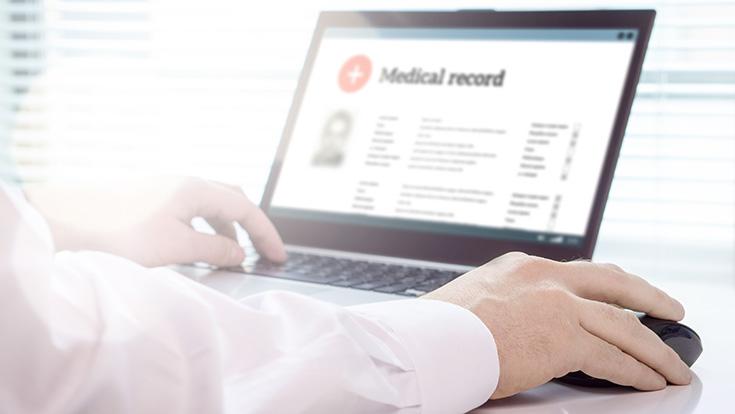 A person filling out a medica record online