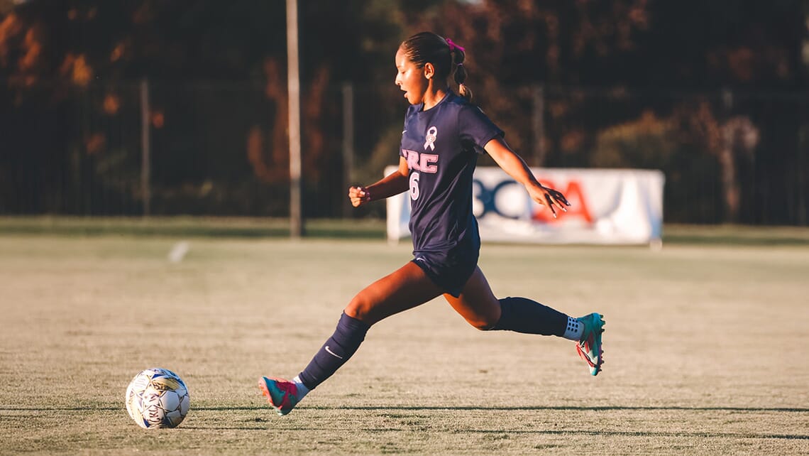 CRC female soccer player dribbling the ball