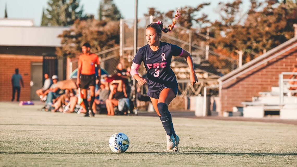CRC female soccer player chasing the ball