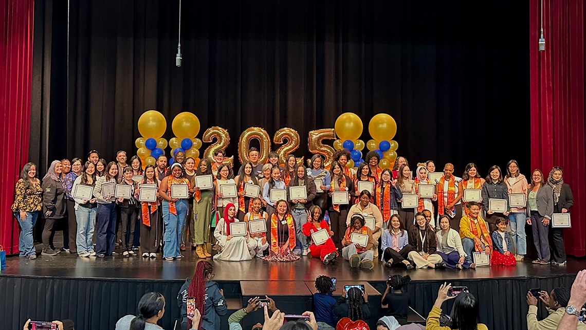 Care students on stage with balloons