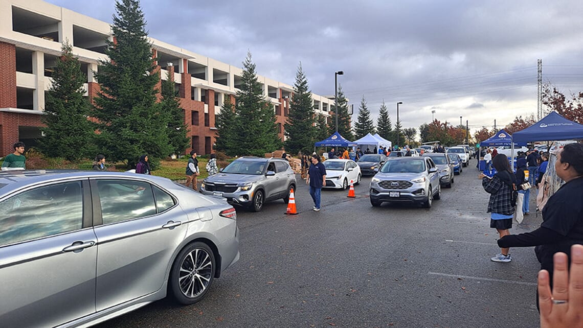 A drive-through event organized by the Hawk CARES Center; a line of cars