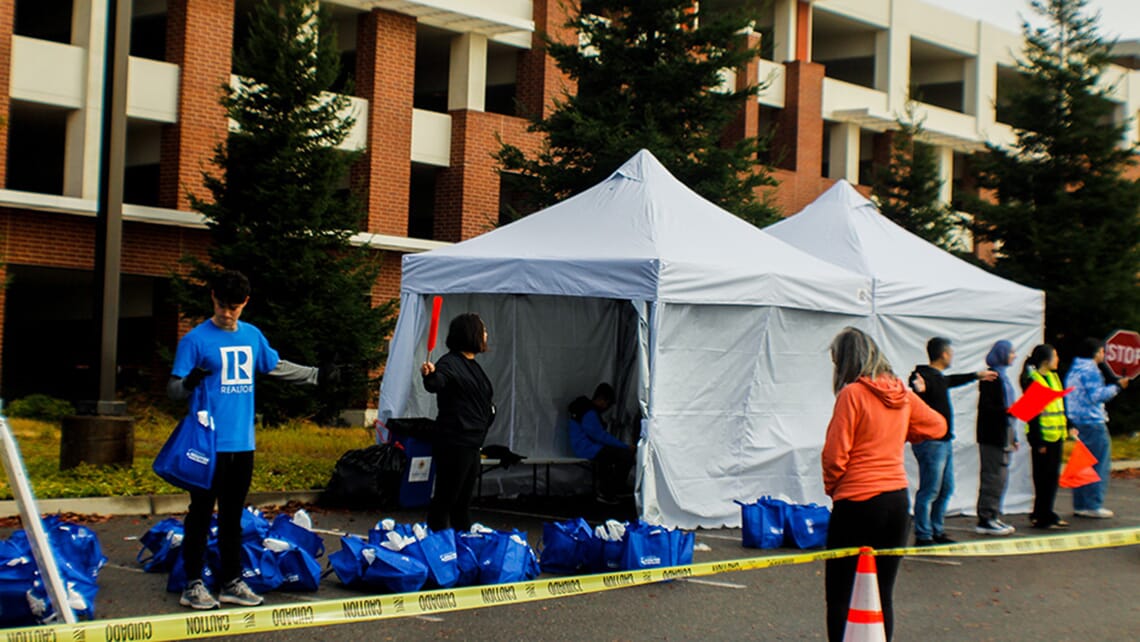 A drive-through event organized by the Hawk CARES Center; a row of tents housing supplies to be distributed