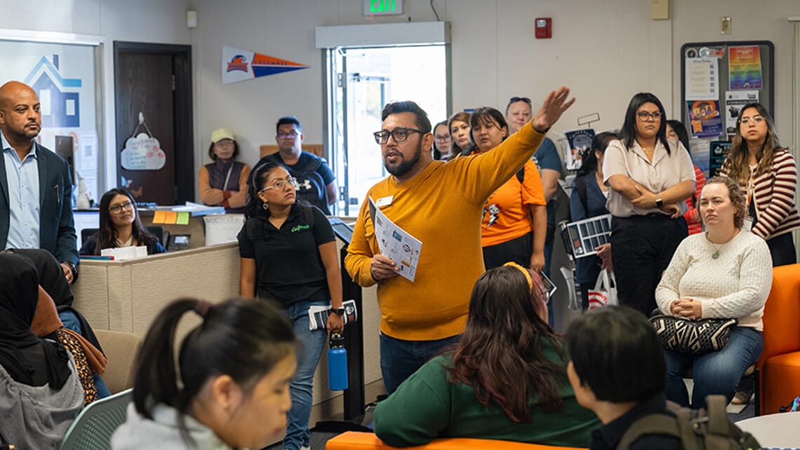 Oscar Mendoza Plascencia, Hawk CARES Director, giving a speech inside the Hawk CARES Center