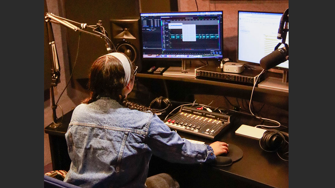 The back view of a person working at an editing desk
