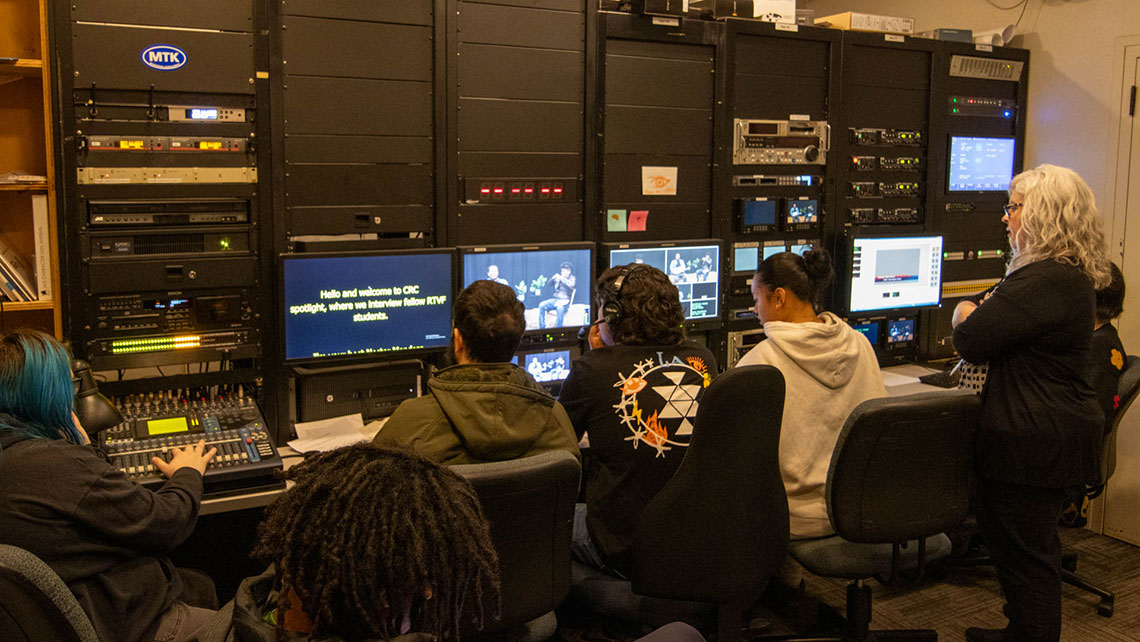 Students working at production desk, left angle
