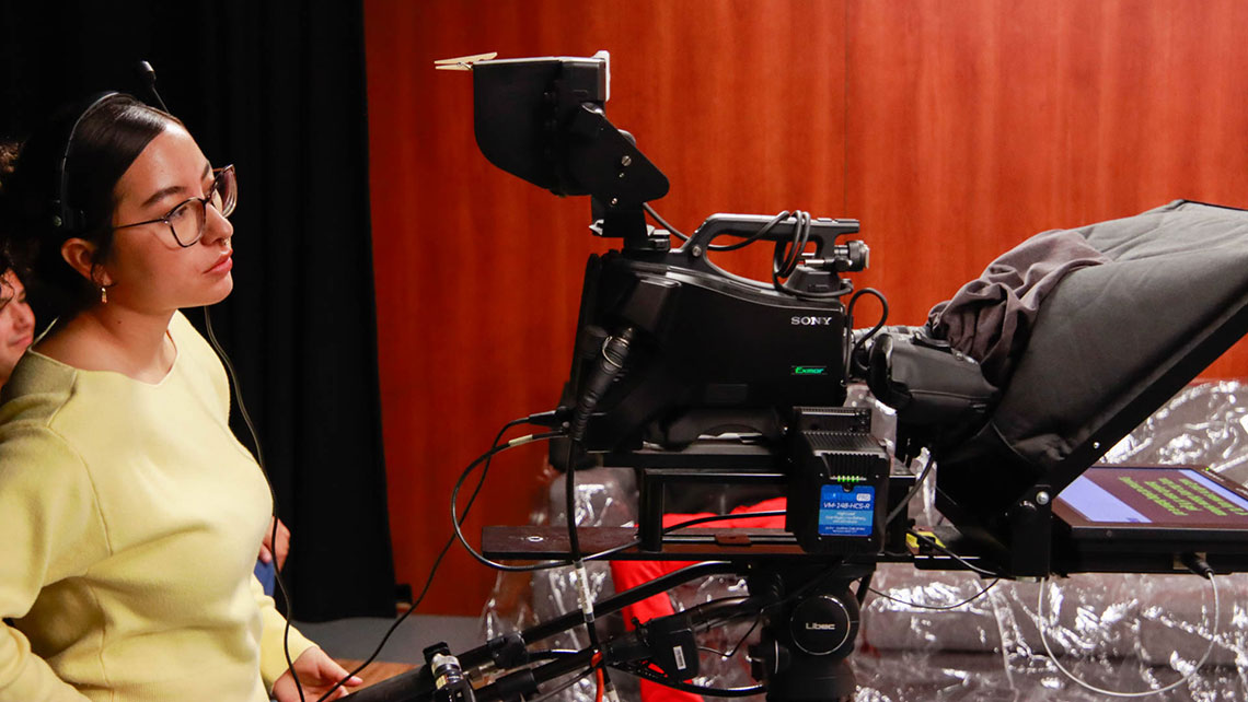The side view of a person operating a video camera
