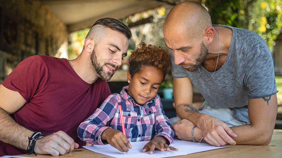 Dads helping their young daughter with homework