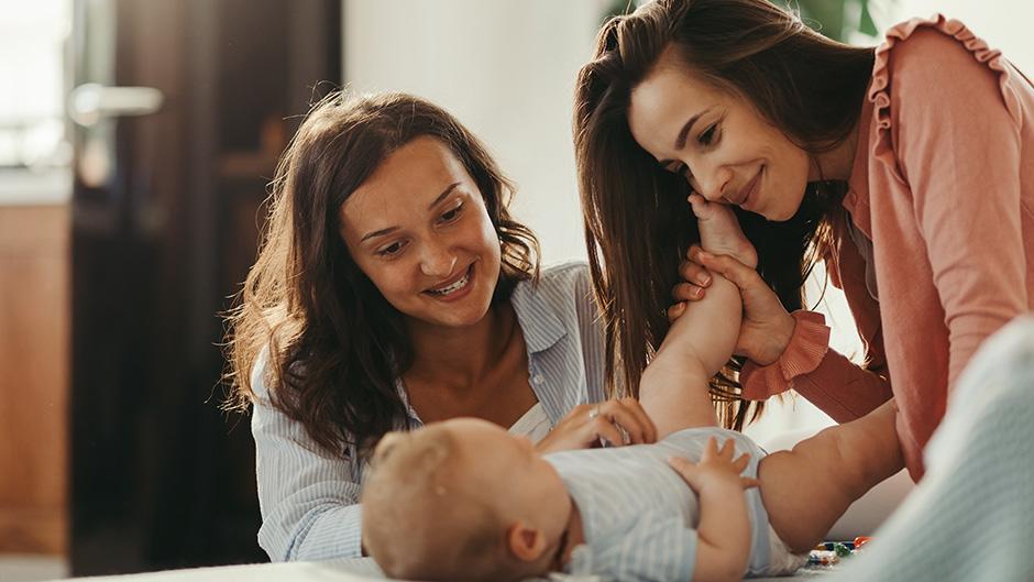 Moms changing the diaper of their baby