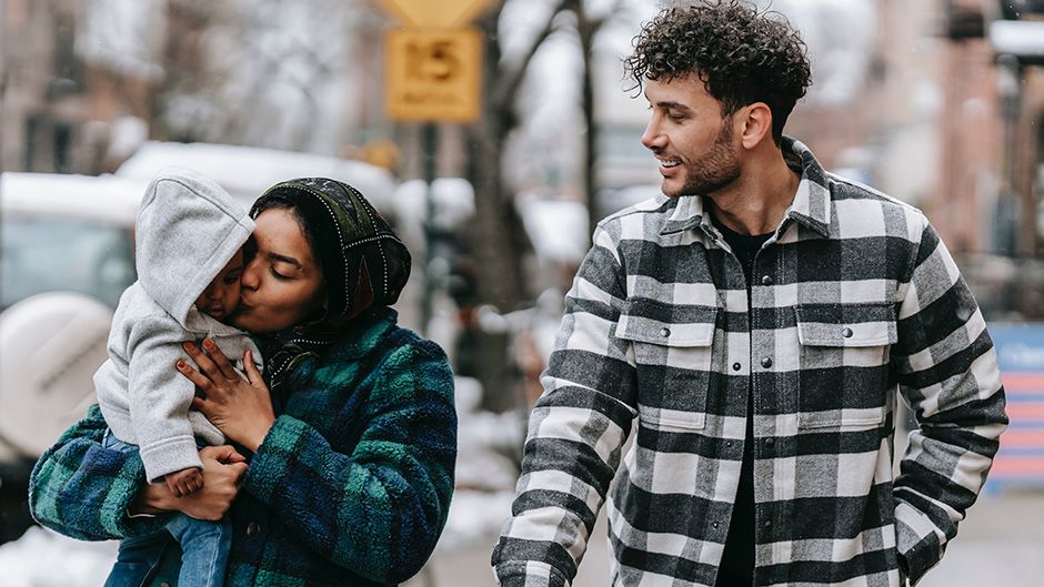 Mother and father with baby in a city