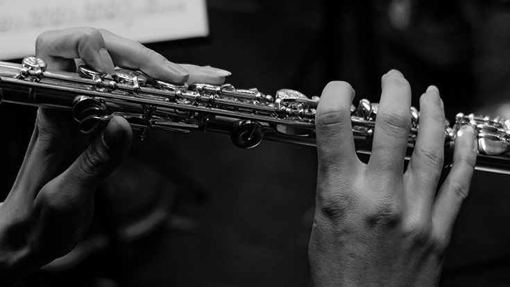 Hands playing a flute