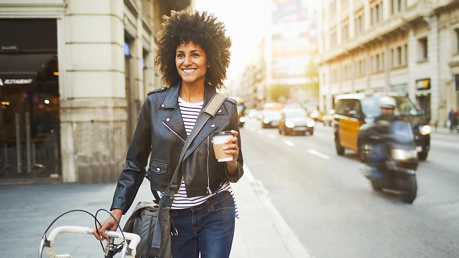 woman walking bike in Barcelona Spain